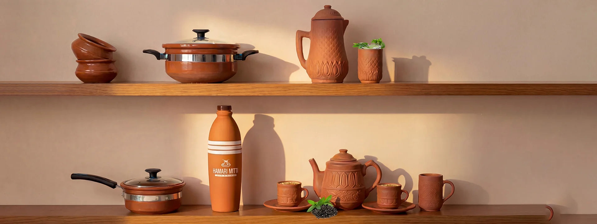 Collection of terracotta kitchenware on wooden shelves with a warm beige background.